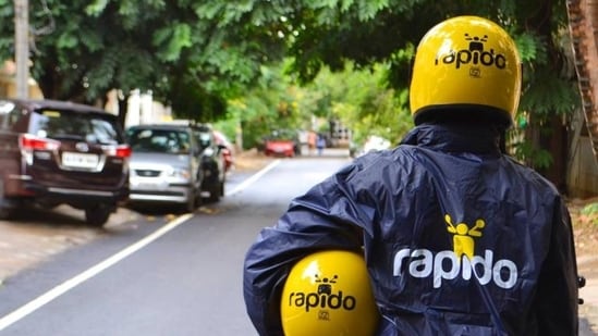 Mumbai, India - October 30, 2020: Mumbai residents now have an option to use a bike taxi to reach a particular destination faster despite heavy traffic. Transport authorities have given permission for bike taxis to operate; the first such service was launched on Friday. Commuters will be able to book a bike taxi by downloading the Rapido mobile phone application. Passengers will have to create an account on the mobile application. The facility is available on both android and IOS platforms.