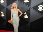 Paris Hilton arrived at the 66th Annual Grammy Awards looking glamorous in a sheer gown adorned with mesmerising blue embellishments and silver tassels all over. Paris Hilton arrived at the 66th Annual Grammy Awards looking glamorous in a sheer gown adorned with mesmerising blue embellishments and silver tassels all over.