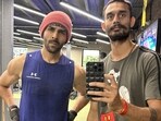 Actor Kartik Aaryan and trainer Tridev Pandey (right)