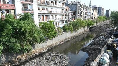 . During a spot check on Thursday, silt and garbage from the nullah had been partly excavated and stashed along the lane, leaving a narrow opening for the sewage water to pass through. However, the situation remained unchanged further down, where the drain was still replete with trash and plastic material. (Arvind Yadav/HT Photo) . During a spot check on Thursday, silt and garbage from the nullah had been partly excavated and stashed along the lane, leaving a narrow opening for the sewage water to pass through. However, the situation remained unchanged further down, where the drain was still replete with trash and plastic material. (Arvind Yadav/HT Photo)