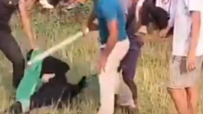The viral video showed a woman being beaten up by a group of men armed with thick sticks (Twitter/video screengrab)