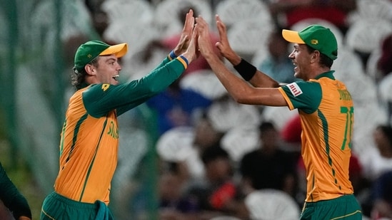 South Africa's Tristan Stubbs, left, celebrates with teammate Marco Jansen after taking a catch to dismiss Afghanistan's Azmatullah Omarzai (AP)