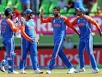 India's Axar Patel and teammates celebrate the wicket of England's captain Jos Buttler during their semi-final match in the ICC Mens T20 World Cup