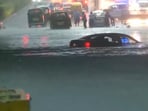 The image shows a waterlogged road in Delhi. The image shows a waterlogged road in Delhi.