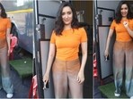 Shraddha Kapoor's chic and minimalist fashion sense shines in a casual orange T-shirt and denim pants outfit.