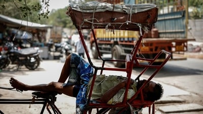 A man sleeps in his rickshaw during a heatwave on a hot summer day in New Delhi. (REUTERS)