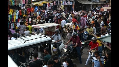 Bikers struggle to wade through a sea of shoppers at the Aminabad market. (Mushtaq Ali/HT) Bikers struggle to wade through a sea of shoppers at the Aminabad market. (Mushtaq Ali/HT)