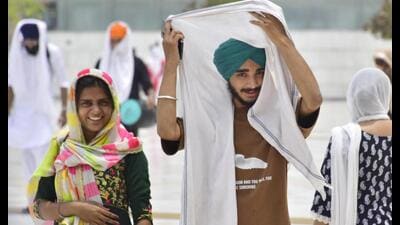 Commuters shield themselves with scarves on a hot summer day in Amritsar on Friday. (Sameer Sehgal /HT) Commuters shield themselves with scarves on a hot summer day in Amritsar on Friday. (Sameer Sehgal /HT)
