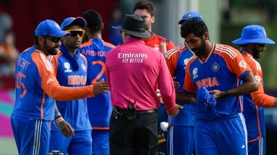 India's captain Rohit Sharma (L) and India's Jasprit Bumrah (R) are congratulated by the umpire (AFP) India's captain Rohit Sharma (L) and India's Jasprit Bumrah (R) are congratulated by the umpire (AFP)