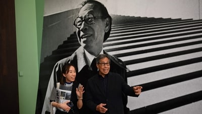 Sandi Pei (R), son of renowned Chinese-American architect I.M. Pei, is photographed in front of a photo of his father after a media preview of "I. M. Pei: Life Is Architecture", the first full-scale retrospective of I. M. Pei (1917-2019), one of the most influential architects of the twentieth and twenty-first centuries at the M+ art museum in Hong Kong. (AFP) Sandi Pei (R), son of renowned Chinese-American architect I.M. Pei, is photographed in front of a photo of his father after a media preview of "I. M. Pei: Life Is Architecture", the first full-scale retrospective of I. M. Pei (1917-2019), one of the most influential architects of the twentieth and twenty-first centuries at the M+ art museum in Hong Kong. (AFP)
