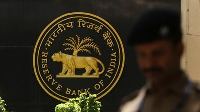 A police officer walks past the Reserve Bank of India (RBI) logo inside its headquarters in Mumbai, India. (Reuters)