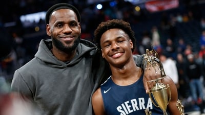 Los Angeles Lakers forward LeBron James, left, poses with his son Bronny after Sierra Canyon defeated Akron St. Vincent-St. Mary in a high school basketball game (AP) Los Angeles Lakers forward LeBron James, left, poses with his son Bronny after Sierra Canyon defeated Akron St. Vincent-St. Mary in a high school basketball game (AP)