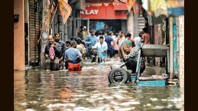 People and vehicles stuck on a waterlogged road near Sarai Kale Khan after heavy rain in Delhi on Friday. (PTI) People and vehicles stuck on a waterlogged road near Sarai Kale Khan after heavy rain in Delhi on Friday. (PTI)