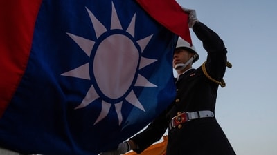 A honor guard takes part in a flag lowering ceremony at Chiang Kai Shek Memorial Hall in Taipei, Taiwan (AP)