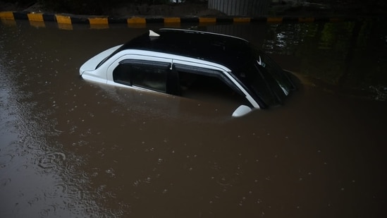 Heavy rains in Noida resulted in several underpasses becoming flooded, leading to vehicles getting stuck.(Sunil Ghosh/Hindustan Times)