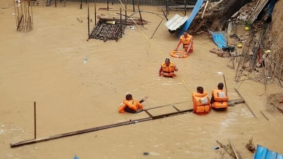 Five to six labourers are feared to be trapped under the mud slush after an under-construction wall collapsed in southwest Delhi's Vasant Vihar area. According to the officials of the Delhi Fire Service (DFS), a call regarding a wall collapse was received at 5.30 am and five fire tenders were pressed into service.(Vipin Kumar/Hindustan Times)