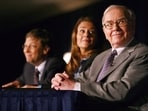 FILE PHOTO: Chairman of Berkshire Hathaway Inc. Warren Buffett listens while Bill and Melinda Gates look on during a news conference in New York June 26, 2006.  