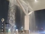 A video shows water pouring down at Delhi Airport.