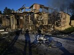 The body of a local resident and damaged building of a grocery store are seen at a site of a Russian missile strike, amid Russia's attack on Ukraine, in the town of Vilniansk, Zaporizhzhia region, Ukraine 