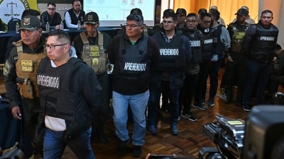 Military Mario Mauricio Cabiedes, Waldir Mamani Higalgo, Luis Domingo Balanza, Miguel fernando Iriarte, Leonel Elio Sanjines, Julio Omar Buitrago and Roman Caba Cosio are escorted by policemen following their arrest (AFP)