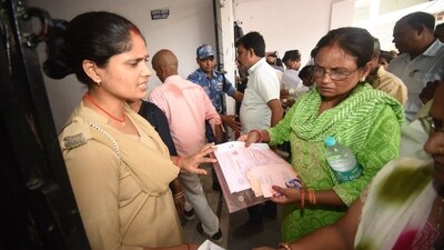 Security officials go through the documents of aspirants before admitting them to the exam hall in Patna. (Santosh Kumar) Security officials go through the documents of aspirants before admitting them to the exam hall in Patna. (Santosh Kumar)