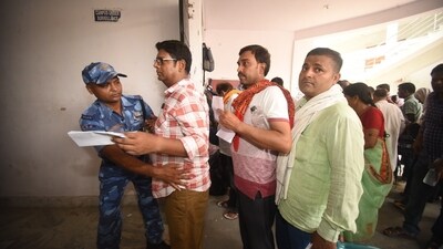 Aspirants are inspected by police before entering an examination center to appear for the Head Master exam conducted by Bihar Public Service Commission in Patna. (Santosh Kumar) Aspirants are inspected by police before entering an examination center to appear for the Head Master exam conducted by Bihar Public Service Commission in Patna. (Santosh Kumar)