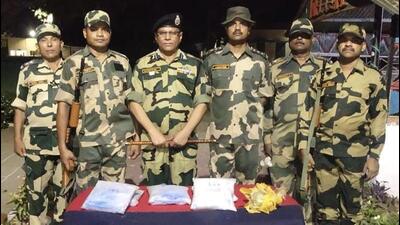 Border Security Force (BSF) personnel with the heroin seized from two drones in Amritsar district, on Saturday. (HT Photodistrict)