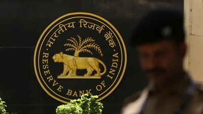 A police officer walks past the Reserve Bank of India (RBI) logo inside its headquarters in Mumbai (Reuters)
