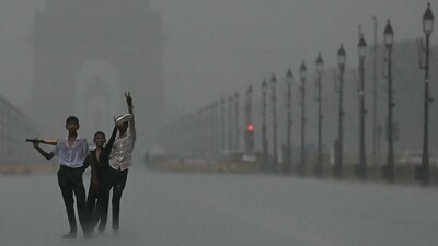 Weather updates: Children enjoy at the India Gate during heavy rainfall in New Delhi on June 29. ( (Photo by Arun SANKAR / AFP)) Weather updates: Children enjoy at the India Gate during heavy rainfall in New Delhi on June 29. ( (Photo by Arun SANKAR / AFP))