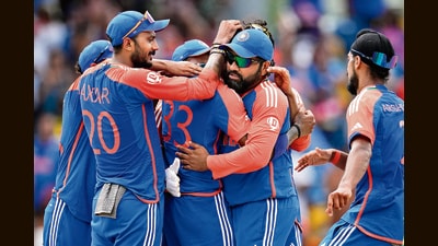 India's captain Rohit Sharma, second right, and teammates celebrate after their win against South Africa in the ICC Men's T20 World Cup final cricket match at Kensington Oval in Bridgetown, Barbados, Saturday. (PTI)