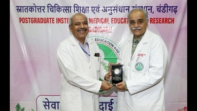 PGIMER director Dr Vivek Lal presenting a memento to Dr Naresh Kumar Panda, dean, academic, and head of the ENT department, (HT Photo) PGIMER director Dr Vivek Lal presenting a memento to Dr Naresh Kumar Panda, dean, academic, and head of the ENT department, (HT Photo)