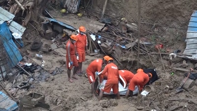 NDRF personnel recover a body from under the debris of a wall that collapsed on Friday at a construction site at Vasant Vihar (PTI) NDRF personnel recover a body from under the debris of a wall that collapsed on Friday at a construction site at Vasant Vihar (PTI)