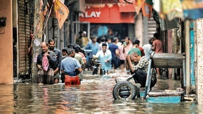 People and vehicles stuck on a waterlogged road near Sarai Kale Khan after heavy rain in Delhi on Friday. (PTI) (HT_PRINT) People and vehicles stuck on a waterlogged road near Sarai Kale Khan after heavy rain in Delhi on Friday. (PTI) (HT_PRINT)