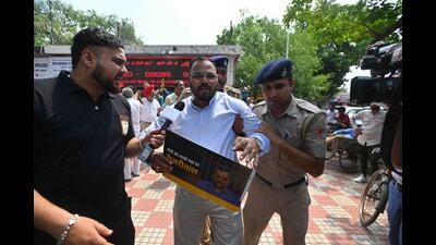 Police detaining Chandigarh mayor Kuldeep Kumar Dhalor during the protest by AAP near the BJP office in Sector 33 on Saturday. (Sanjeev Sharma/HT)