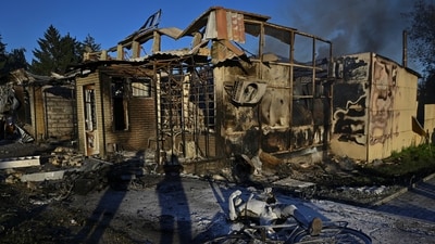 The body of a local resident and damaged building of a grocery store are seen at a site of a Russian missile strike, amid Russia's attack on Ukraine, in the town of Vilniansk, Zaporizhzhia region, Ukraine (via REUTERS)