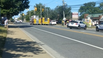 Police vehicles and fire trucks stand nearby a scene where a vehicle crashed into a building, in Long Island, New York, U.S. June 28, 2024 in this screengrab obtained from a social media video. (@FRANCISMPU VIA X via REUTERS)