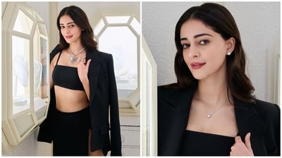 Ananya Pandey's latest look is a black monochrome outfit with a spaghetti strap bralette top, a matching thigh slit mini skirt and a blazer slung over her shoulder. Styled with luxurious diamond jewellery, she oozes effortless glamour. (Instagram) Ananya Pandey's latest look is a black monochrome outfit with a spaghetti strap bralette top, a matching thigh slit mini skirt and a blazer slung over her shoulder. Styled with luxurious diamond jewellery, she oozes effortless glamour. (Instagram)