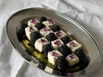 A salad made with blackberries with feta cheese and edible flowers 