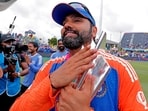 Rohit Sharma poses with the trophy.