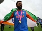 India's Virat Kohli celebrates with the trophy.