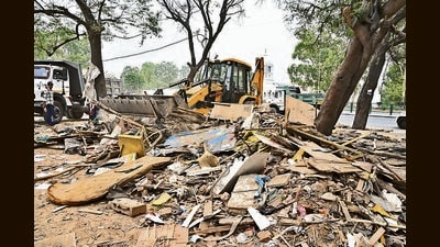 A JCB pulling down illegal shops. The demolition action came against furniture traders who did not respond to the UT notice by June 28. Another 116 shops are slated to be razed. (Keshav Singh/HT) A JCB pulling down illegal shops. The demolition action came against furniture traders who did not respond to the UT notice by June 28. Another 116 shops are slated to be razed. (Keshav Singh/HT)
