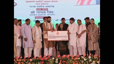 Haryana chief minister Nayab Singh Saini with one of the beneficiaries during a state-level function in Panipat on Sunday. (HT) Haryana chief minister Nayab Singh Saini with one of the beneficiaries during a state-level function in Panipat on Sunday. (HT)