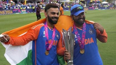 India's Virat Kohli (L) and captain Rohit Sharma pose with the trophy after winning the 2024 T20 World Cup. (PTI)