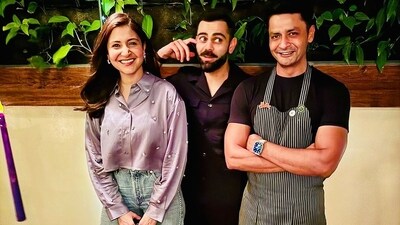 Anushka Sharma and Virat Kohli pose with chef Manu Chandra in the unseen photo.