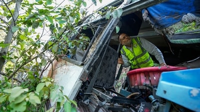A forensic official inspects a bus that fell into a deep gorge on Sunday after being fired at by terrorists in Reasi district, Jammu and Kashmir, Monday, June 10, 2024. (AP) A forensic official inspects a bus that fell into a deep gorge on Sunday after being fired at by terrorists in Reasi district, Jammu and Kashmir, Monday, June 10, 2024. (AP)