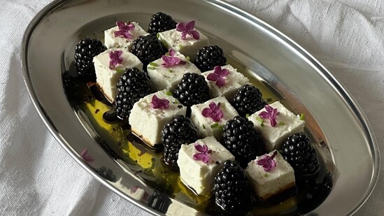 A salad made with blackberries with feta cheese and edible flowers (instagram)