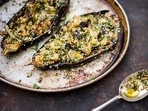 This image released by Milk Street shows a recipe for grilled eggplant with sesame and herbs. 