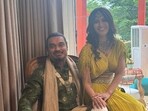 Varalaxmi Sarathkumar and Nicholai Sachdev pose together at their mehendi.