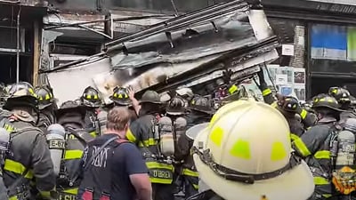 Shocking video shows metal shop awnings crash down on NYC firefighters (Skyler Fire screenshot/YouTube)