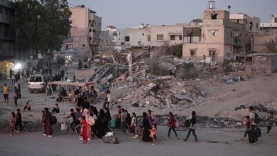 Palestinians displaced by the Israeli air and ground offensive on the Gaza Strip flee from parts of Khan Younis following an evacuation order by the Israeli army to leave the eastern part of Gaza Strip's second largest city on Monday (AP)